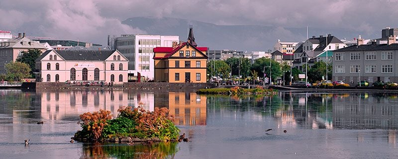 Buildings on far side of body of water