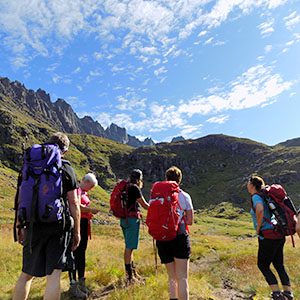 group of backpackers in field in Norway