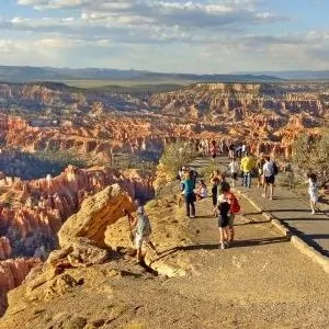 Visitors walk towards the canyon rim for spectacular views.