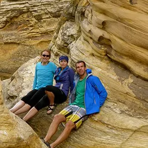 Hikers on tan stone